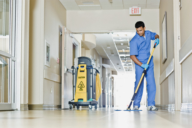 Janitor in hospital hallway
